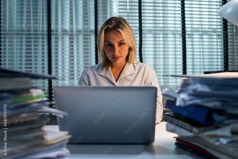 Caucasian businesswoman thinking of problem solution in office night. 