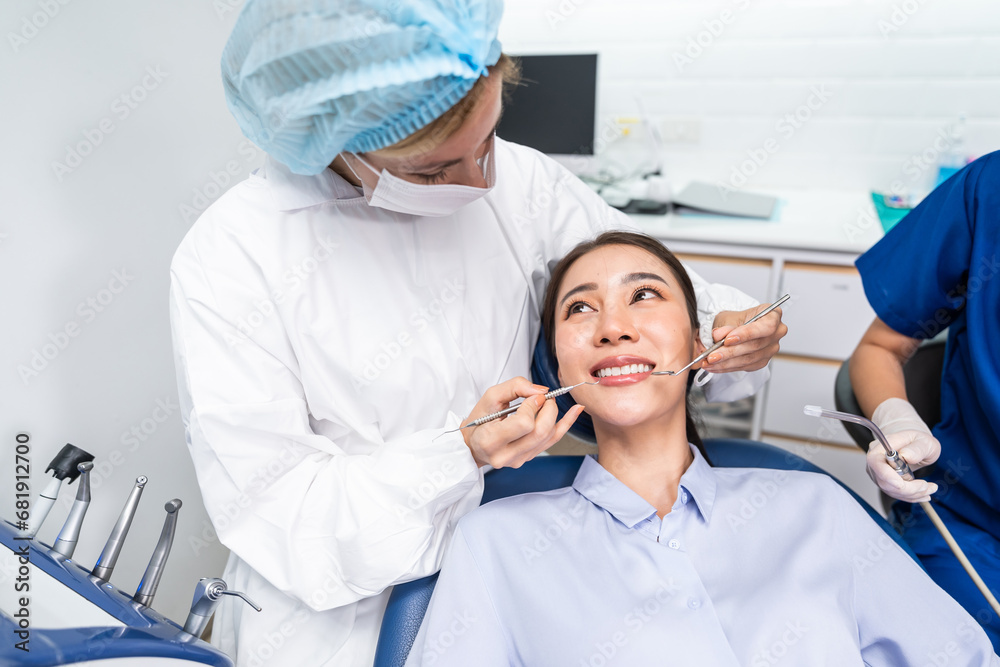 Caucasian dentist examine tooth for young girl at dental health clinic. 