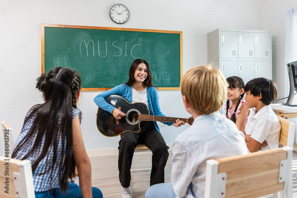 Group of student learn with teacher in classroom at elementary school. 