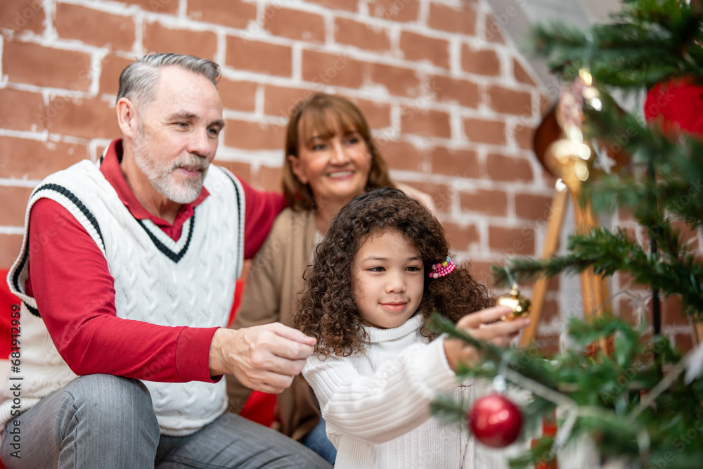 Caucasian family and kid daughter decorating Christmas tree in house. 