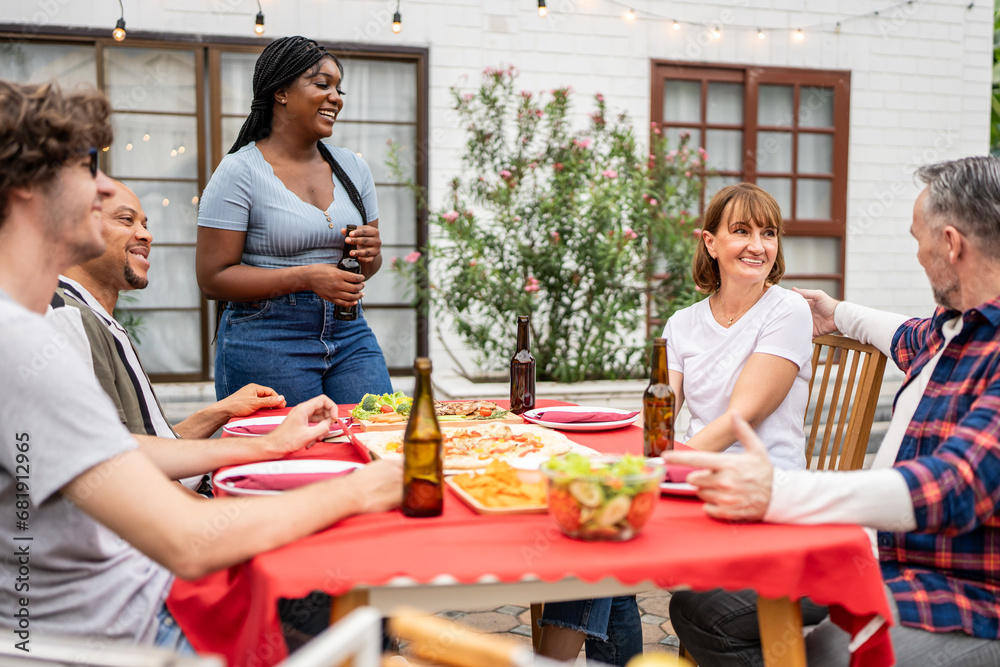 Multi-ethnic family having fun, enjoy party outdoors in the garden. 