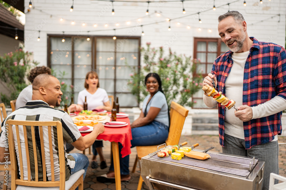 Multi-ethnic family having fun, enjoy party outdoors in the garden. 