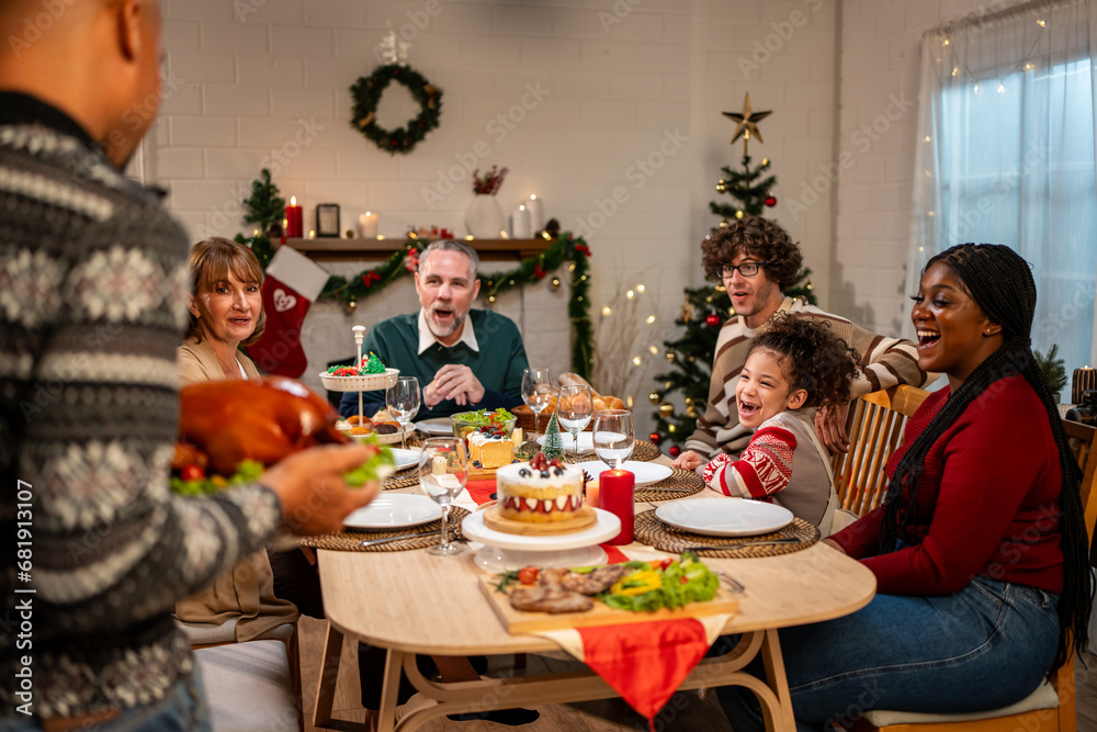 Multi-ethnic big family celebrating Christmas party together in house. 