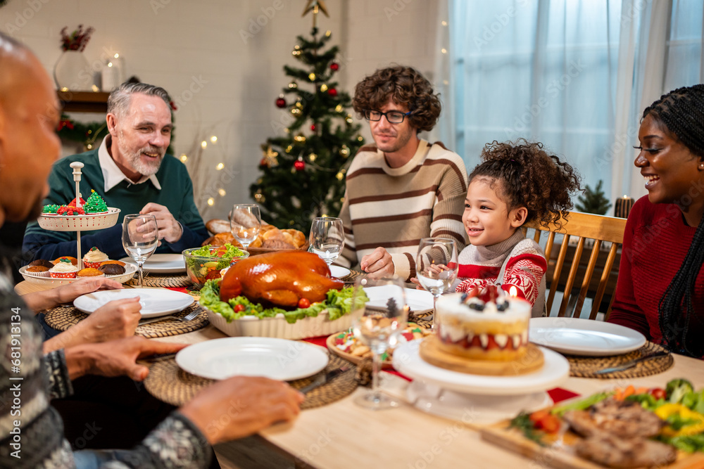 Multi-ethnic big family celebrating Christmas party together in house.