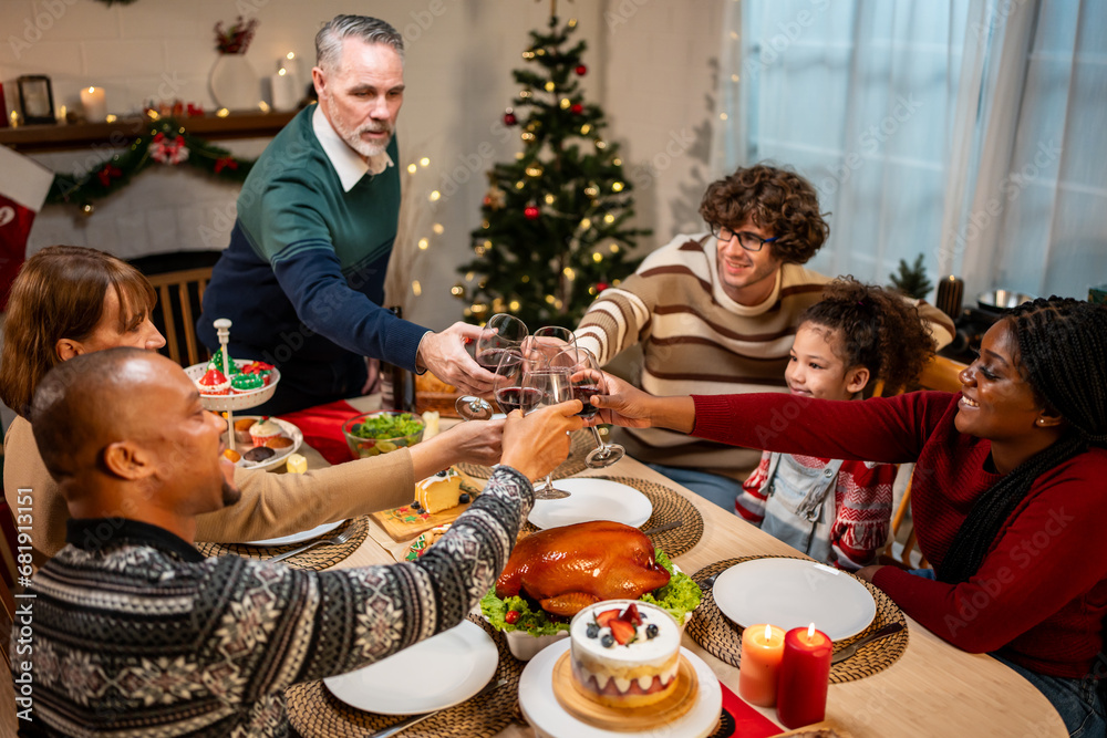 Multi-ethnic big family celebrating Christmas party together in house. 