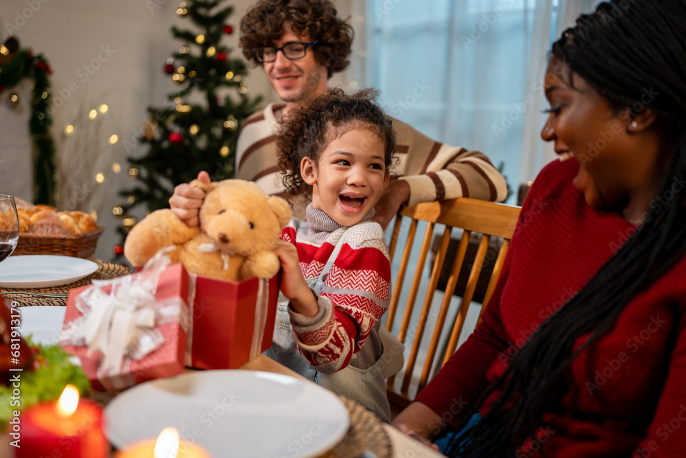 Multi-ethnic family exchanging presents during Christmas party at home. 