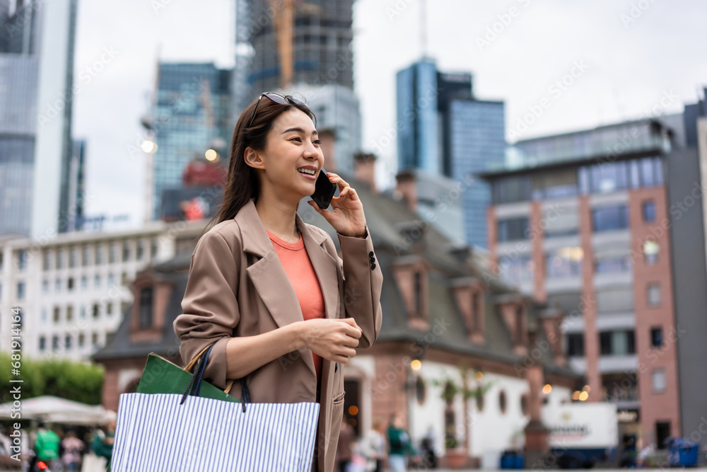 Asian beautiful women talking on phone while walk in department store. 