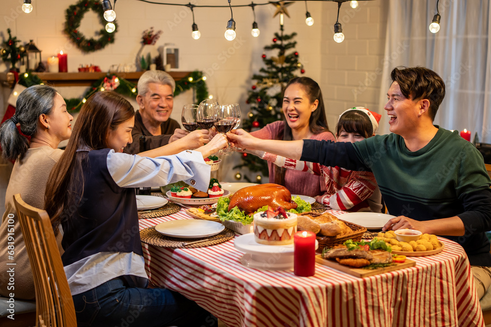 Asian lovely family celebrating Christmas party together in house. 