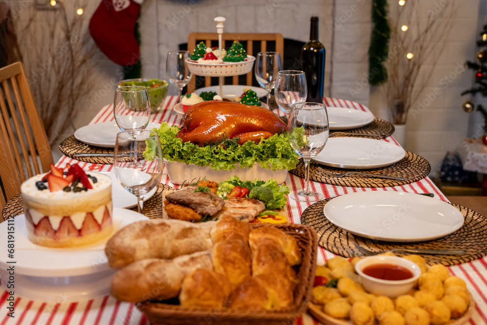 Shot of Christmas turkey and many of foods on table in decorating room.