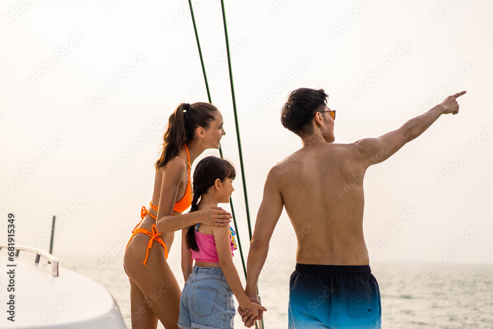 Caucasian happy family walking on deck of yacht while yachting outdoor. 