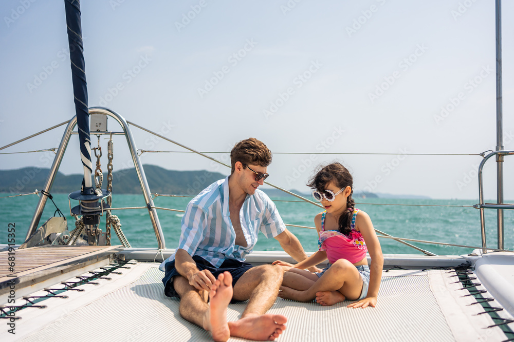 Caucasian happy family sitting on deck of yacht while yachting outdoors. 