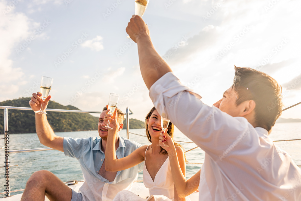 Group of diverse friend sit on deck of yacht while yachting together. 