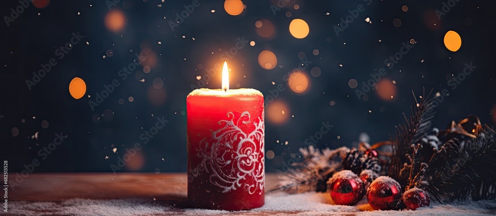 In the vintage winter evening, as darkness fell, a warm and inviting light emanated from the red holiday-themed candle, casting a cozy ambiance.